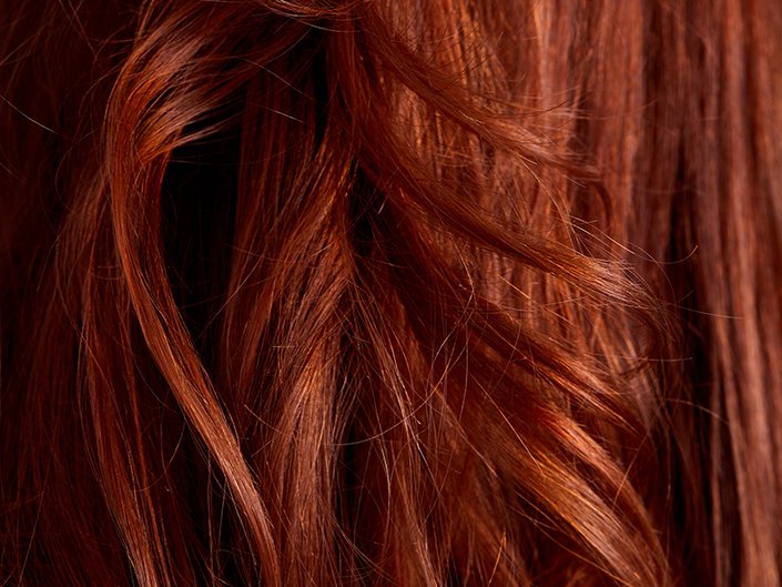 Close-up of long, shiny red hair