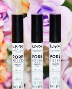 An image of three of the NYX Professional Makeup Pore Filler Targeted Stick against a background of purple and orange flowers