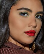 Photo of a model with brown eyes and metallic green eyeshadow