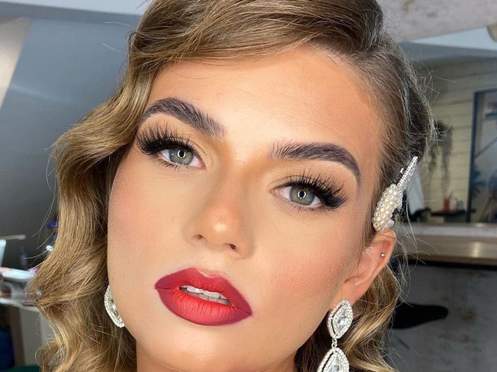 person wearing eyelash extensions and red lipstick