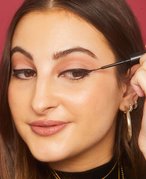 Person applying liquid eyeliner 