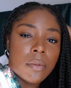 Picture of a person with clear skin and box braids