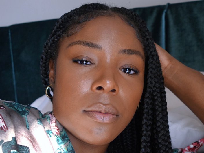 Picture of a person with clear skin and box braids