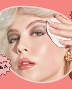 person removing glitter makeup from their eye area