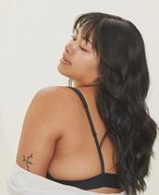 Image of woman with wavy black hair and bangs