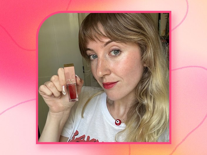 A picture of the editor wearing the Valentino Beauty Liquirosso 2-in-1 Lip & Blush Soft Matte Color on a pink gradient background