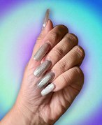 Photo of long silver velvet nails collaged on a blue and green background