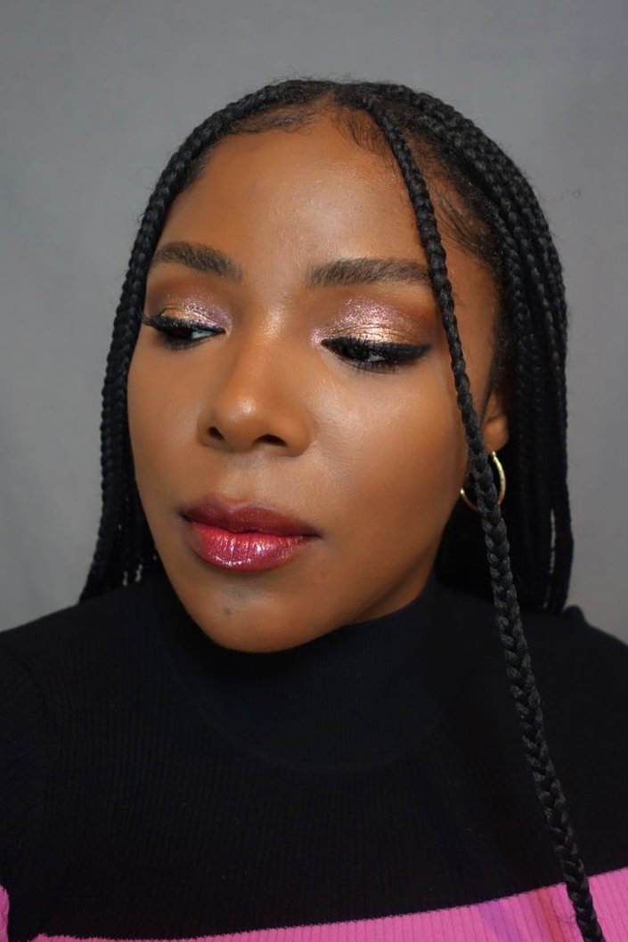 person wearing pink and gold glitter eyeshadow and red sparkly lipstick