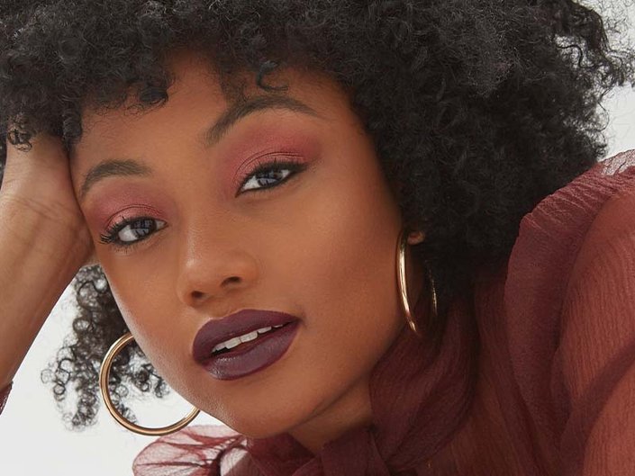 Person wearing dark lipstick and red eyeshadow